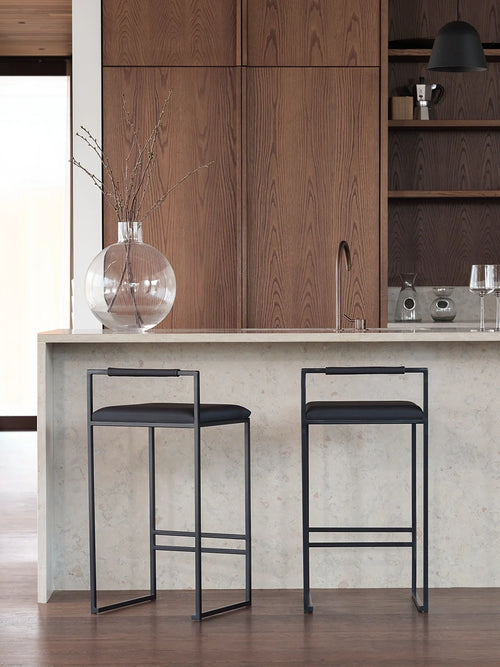 Black Bar Stool Freja with black leather cushion at a modern kitchen island.