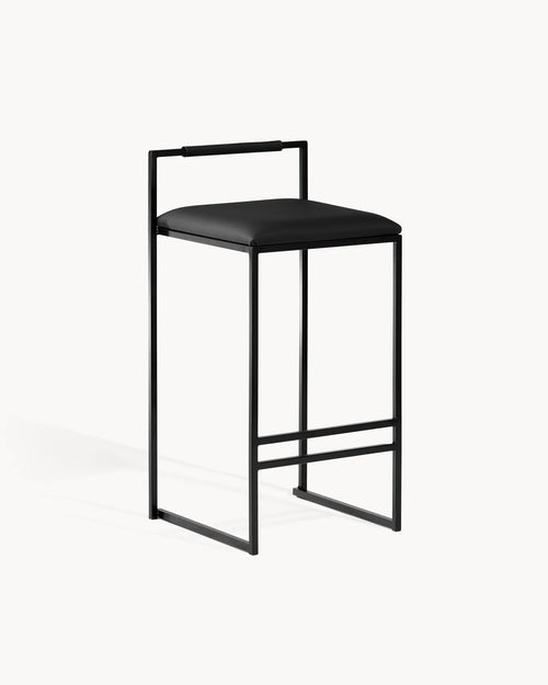 Black Bar Stool Freja with black leather cushion and backrest on slim black frame.