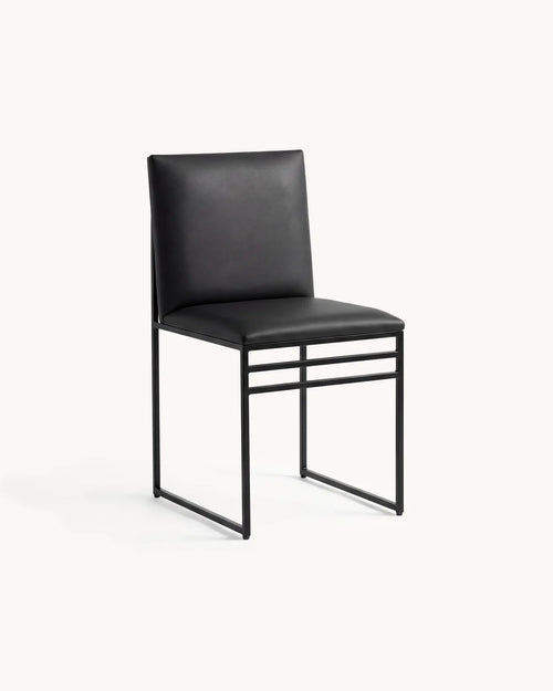 Dining Chair Isabell by Crea in jade black vegan leather on a black powder-coated steel frame, three-quarter view